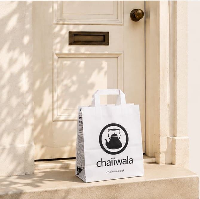A chaiiwala paper bag on a doorstep